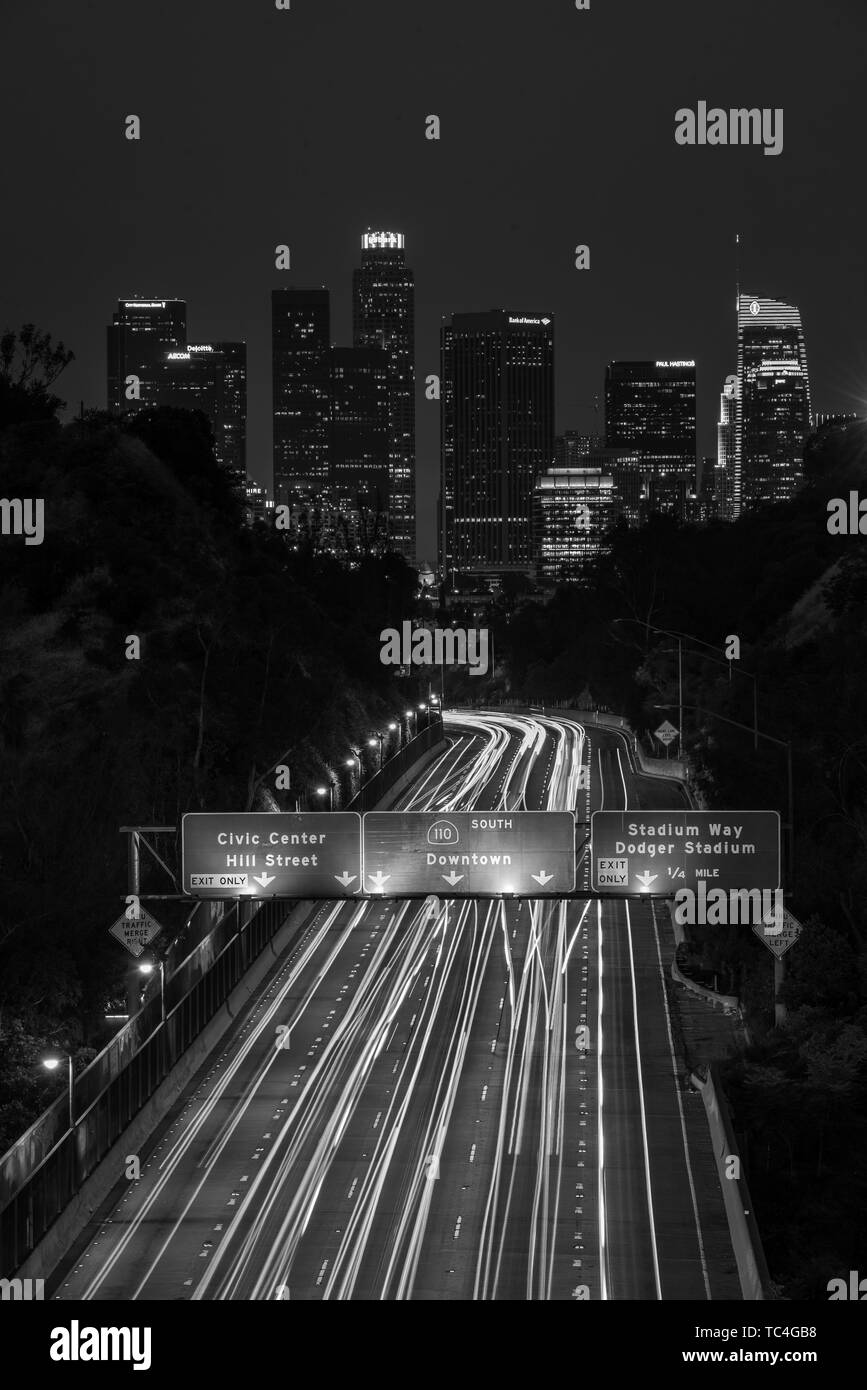 View of the downtown Los Angeles skyline and 110 Freeway at night, from