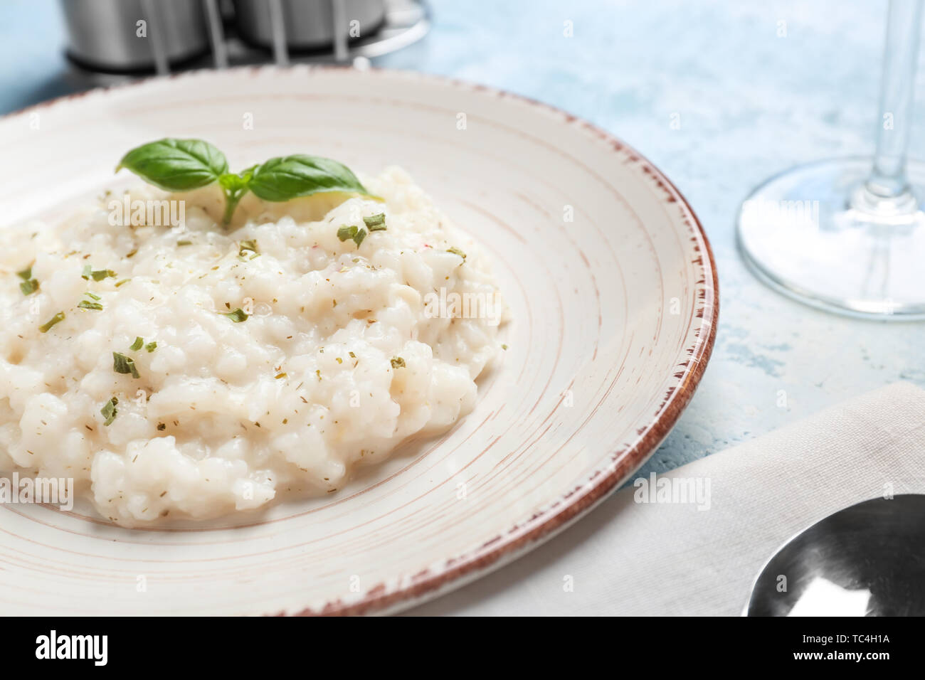 Plate with tasty risotto on table Stock Photo - Alamy
