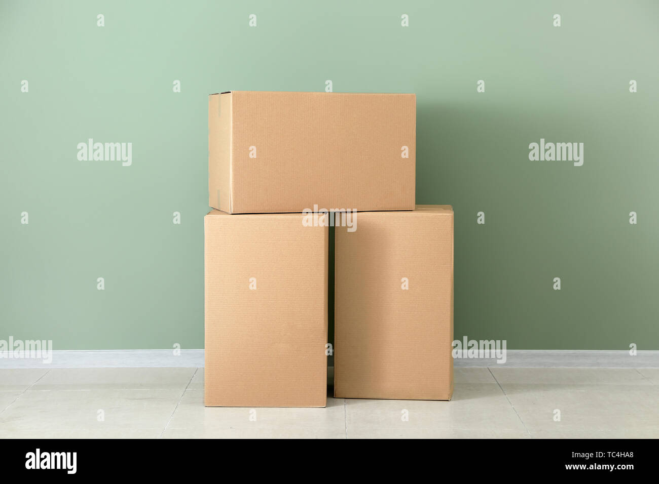 Cardboard boxes near color wall Stock Photo Alamy