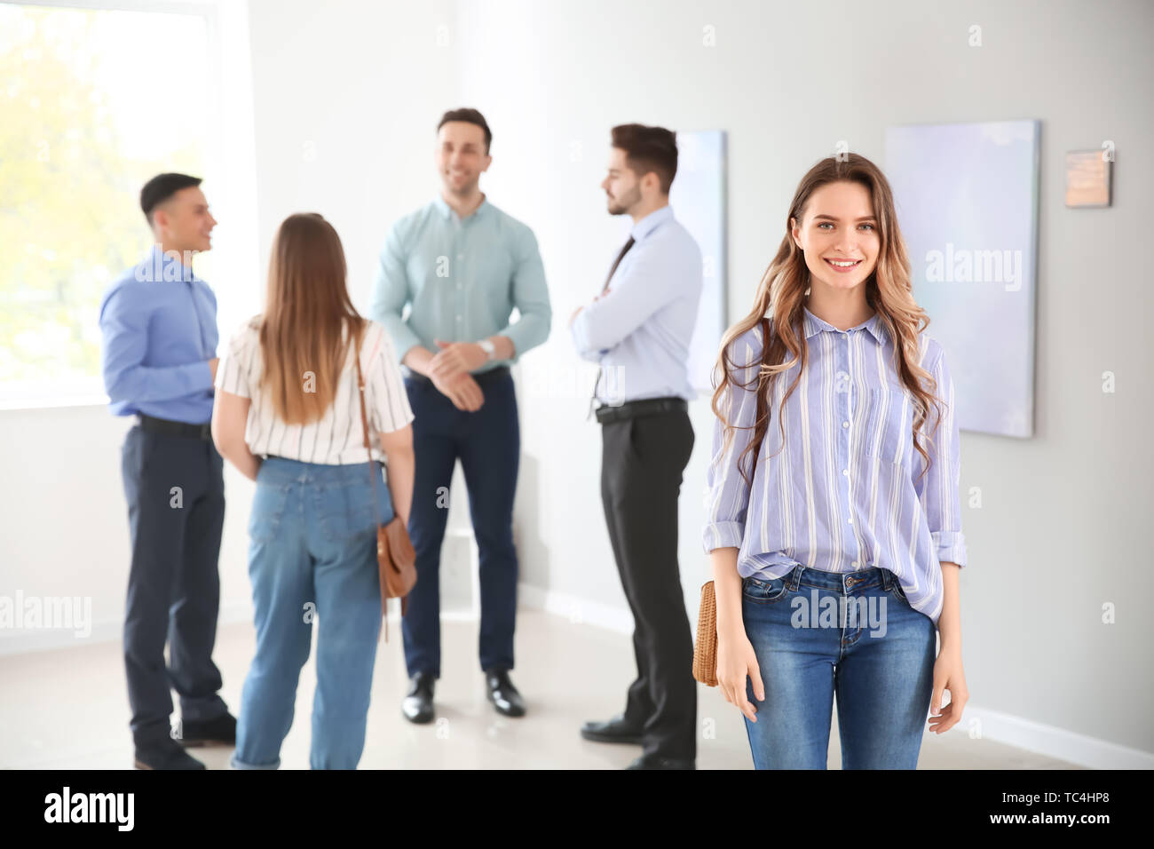 Young woman at exhibition in modern art gallery Stock Photo - Alamy