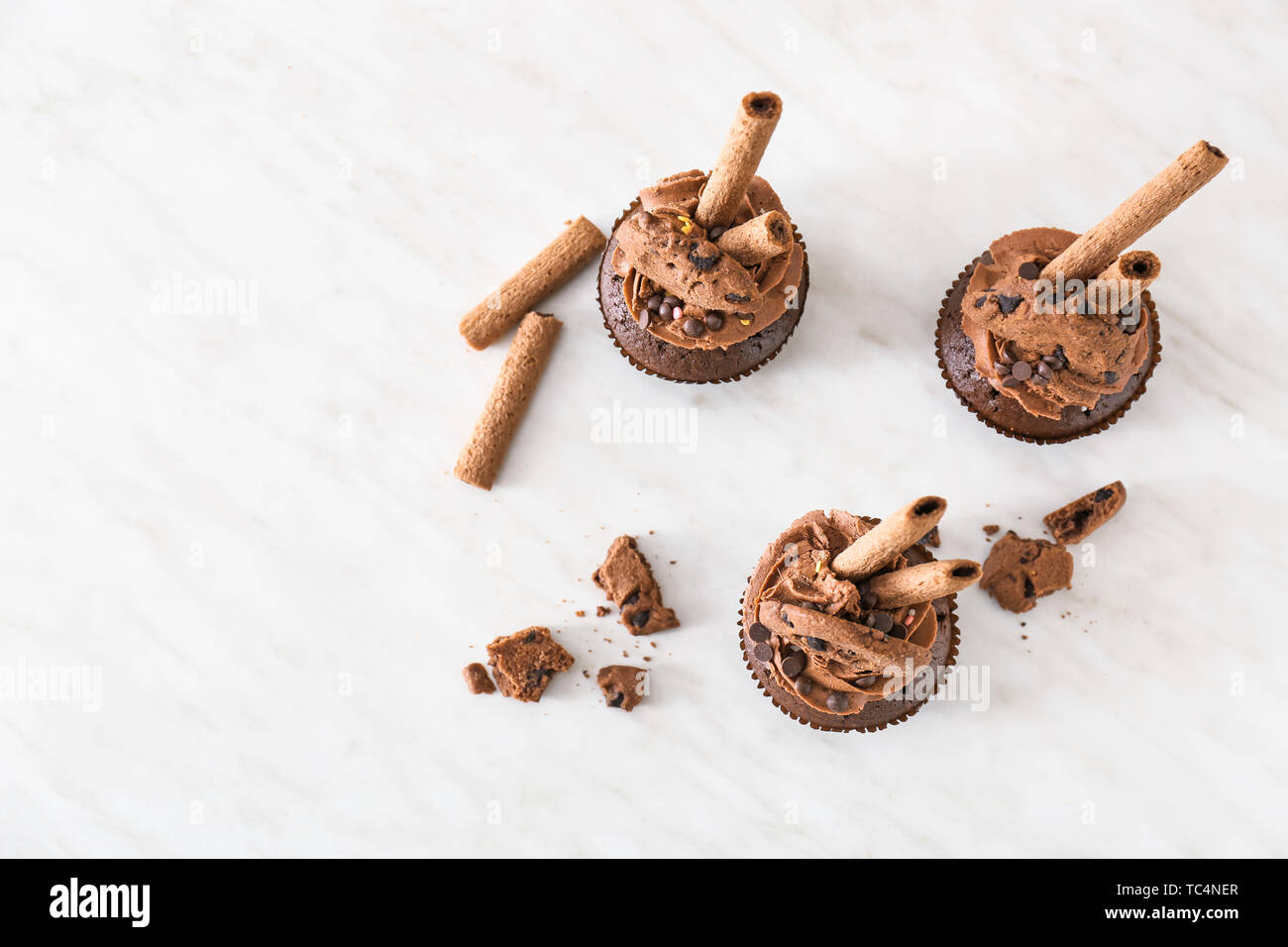 Tasty chocolate cupcakes on light table Stock Photo