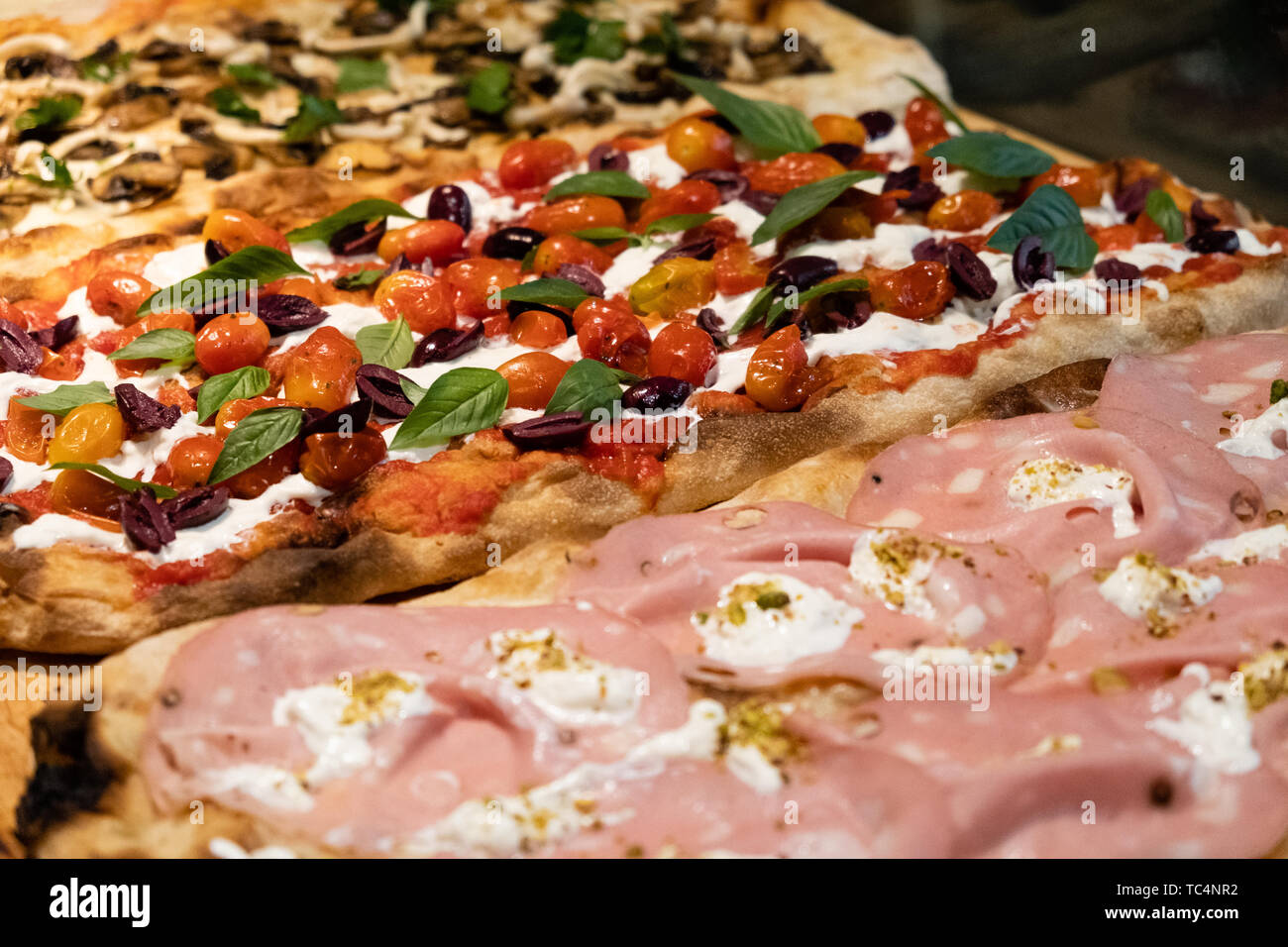 Roman style pizza in pala , high idration , sell by the slice in a gourmet  pizzeria in Rome , Mortadella ham, burrata cheese, pistachio, olive oil, it  Stock Photo - Alamy