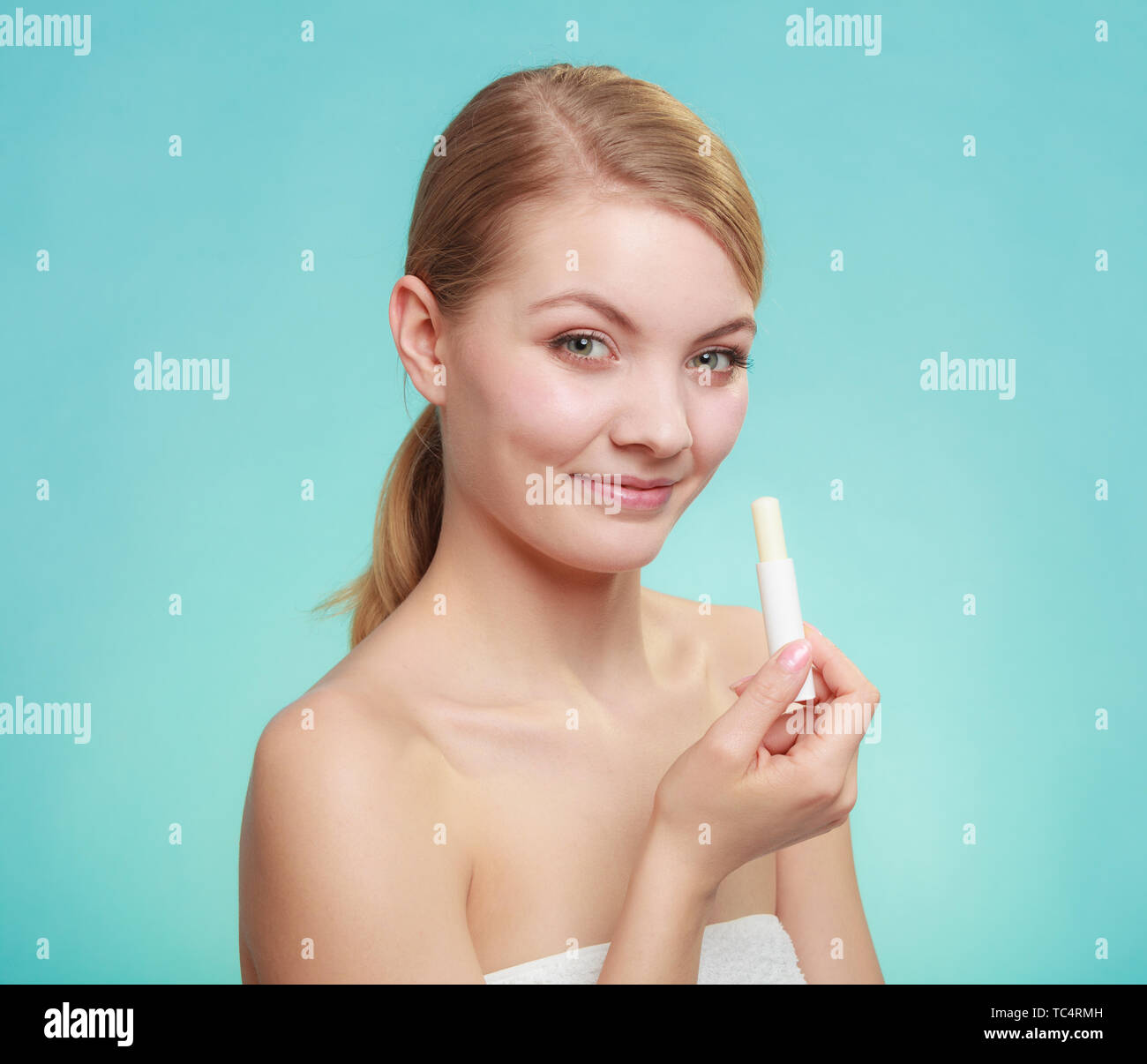 Female putting applying lip balm moisturizing balsam. Girl taking care