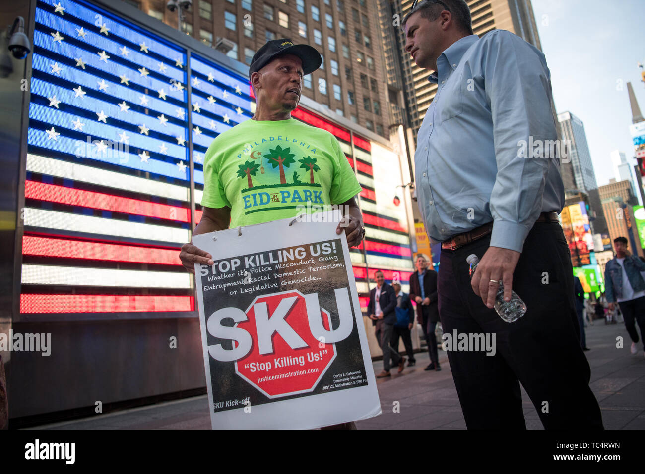Jamal Johnson, disabled Marine Veteran, center, talking to a BLM supporter. - On June 4, 2019, protesters rallied in Times Square in New York City demanding the firing of Officer Pantaleo for the choking death of Eric Garner in 2014. Daniel Pantaleo is currently standing administrative trial which began on May 13. On May 21, the judge overseeing his case delayed the remainder of the hearing until June 5, 2019. Pantaleo has been on desk duty since Eric Garner's death and could face penalties ranging from loss of vacation days to firing from the NYPD. (Photo by Gabriele Holtermann-Gorden/P Stock Photo