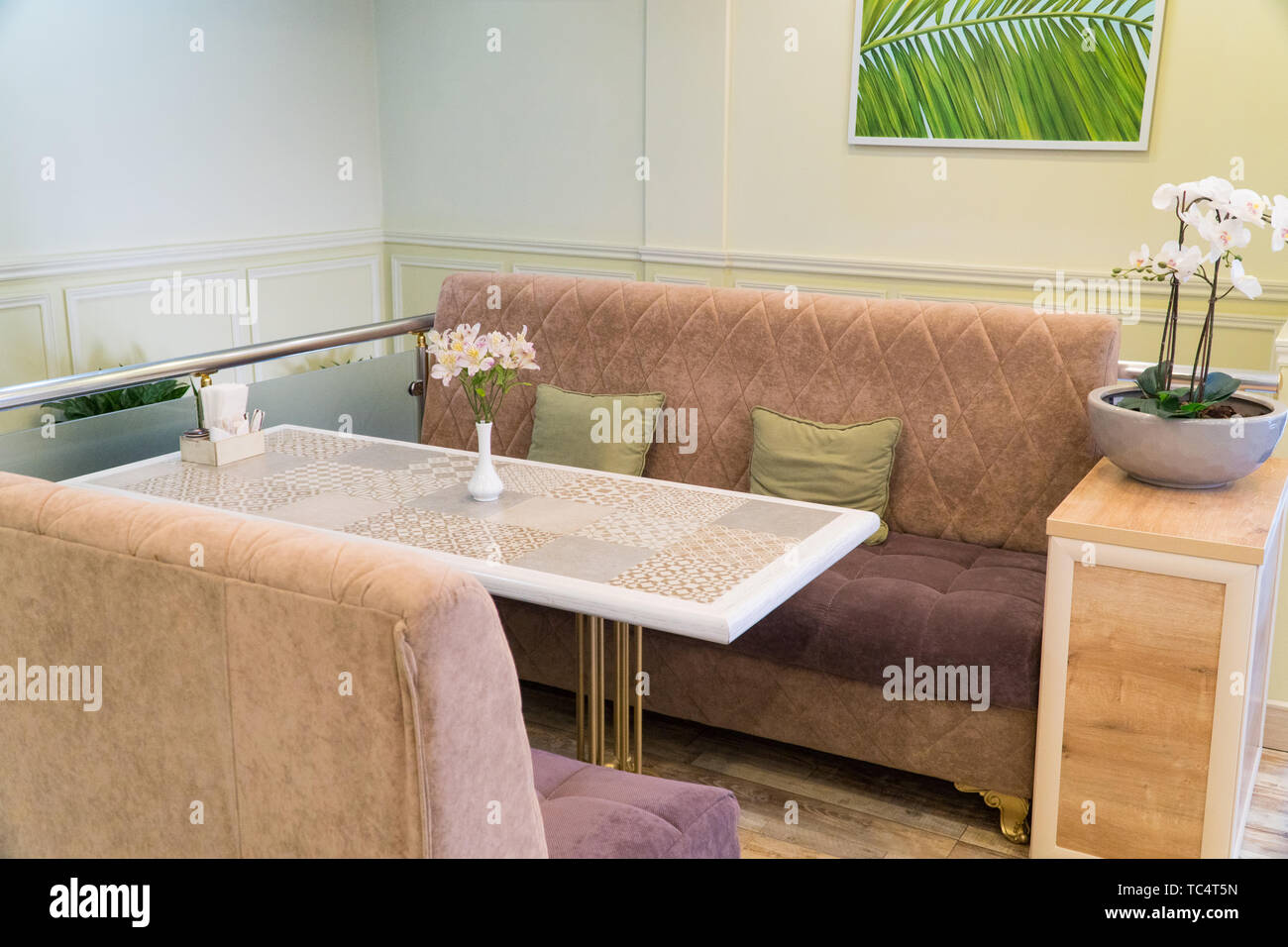 modern restaurant interior with sofa and flowers Stock Photo - Alamy
