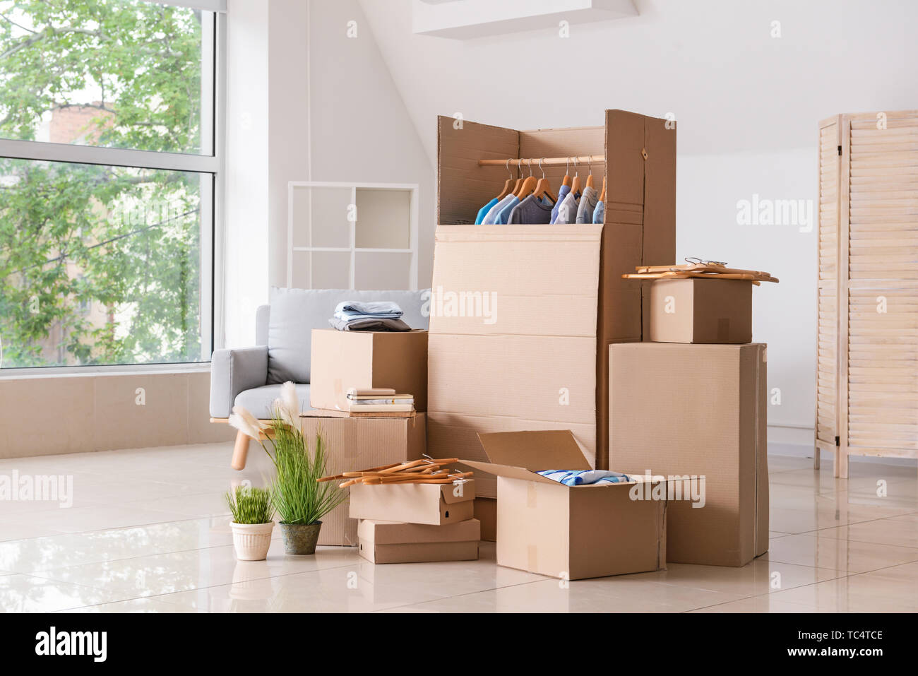 Wardrobe Boxes With Clothes And Other Things In Room Stock Photo