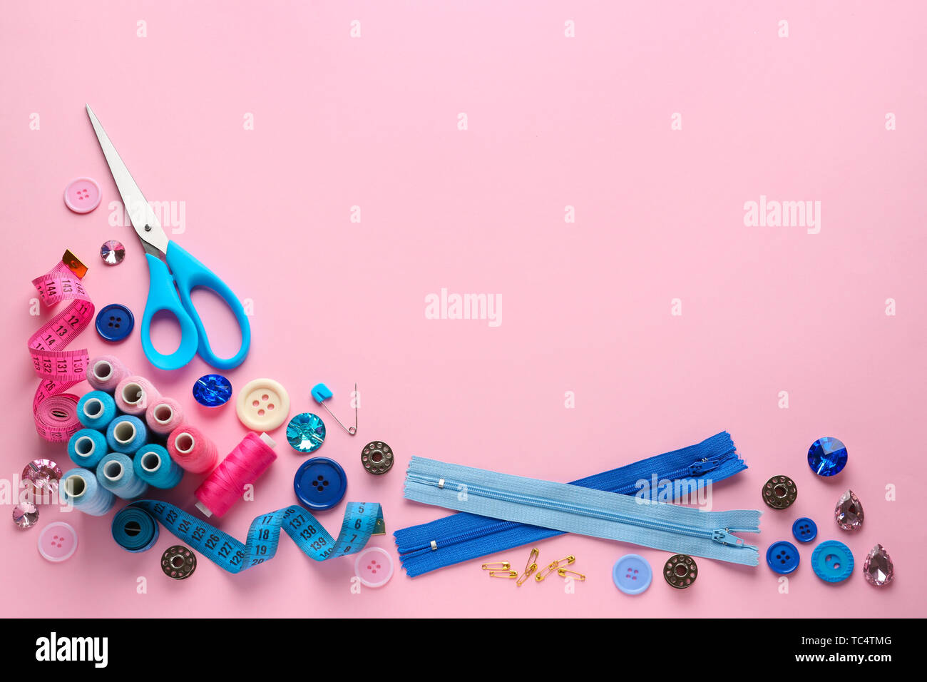 Set of sewing threads and accessories on color background Stock Photo ...