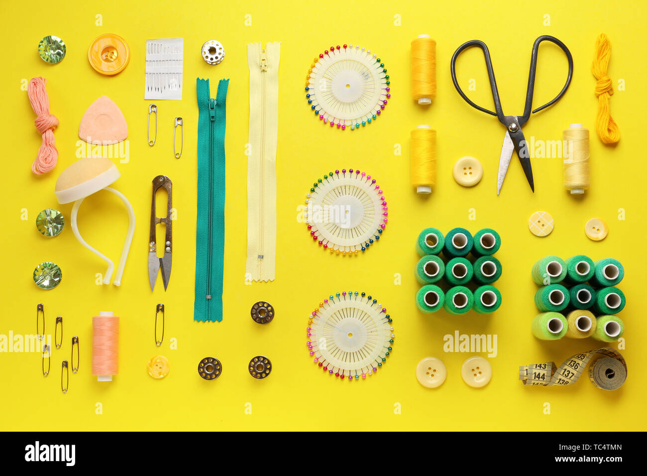 Set of sewing threads and accessories on color background Stock Photo ...