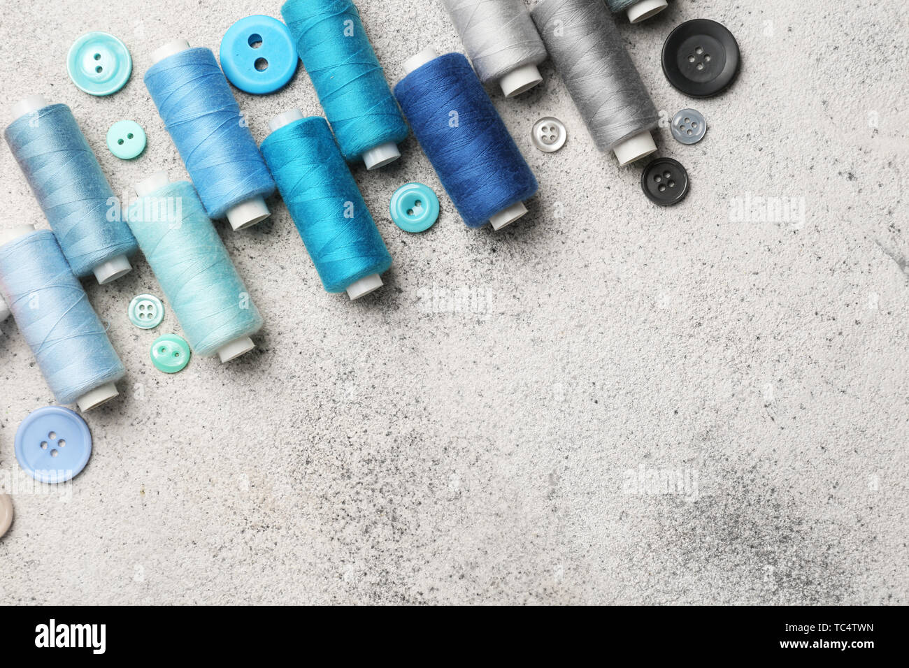 Set of sewing threads and buttons on light background Stock Photo - Alamy