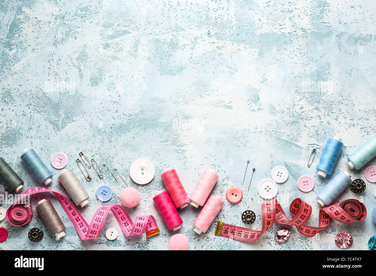 Set of sewing threads and accessories on color background Stock Photo ...