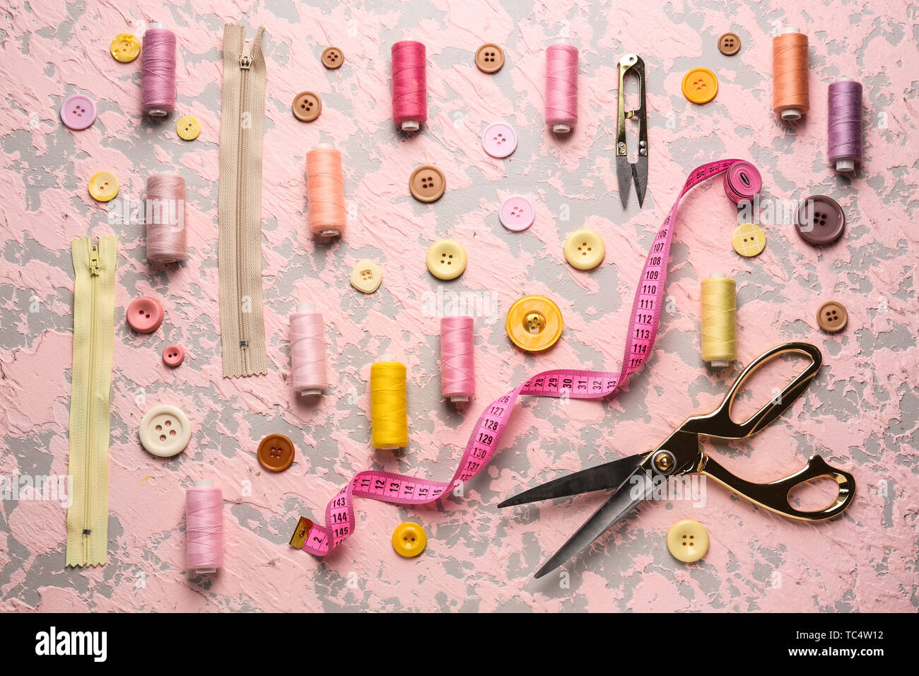 Set of sewing threads and accessories on color background Stock Photo ...