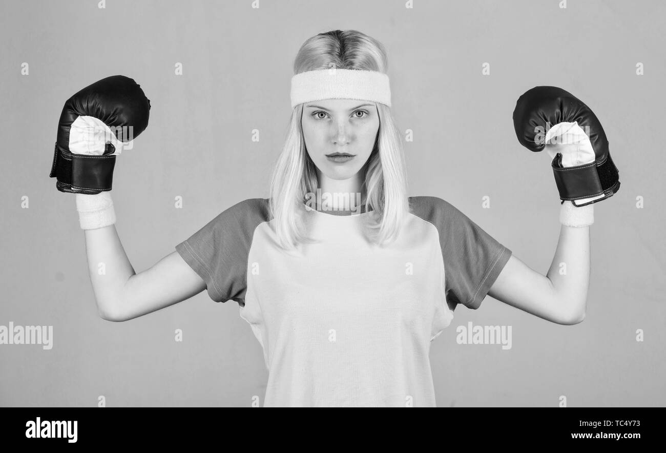 Femininity and strength balance. Woman boxing gloves enjoy workout
