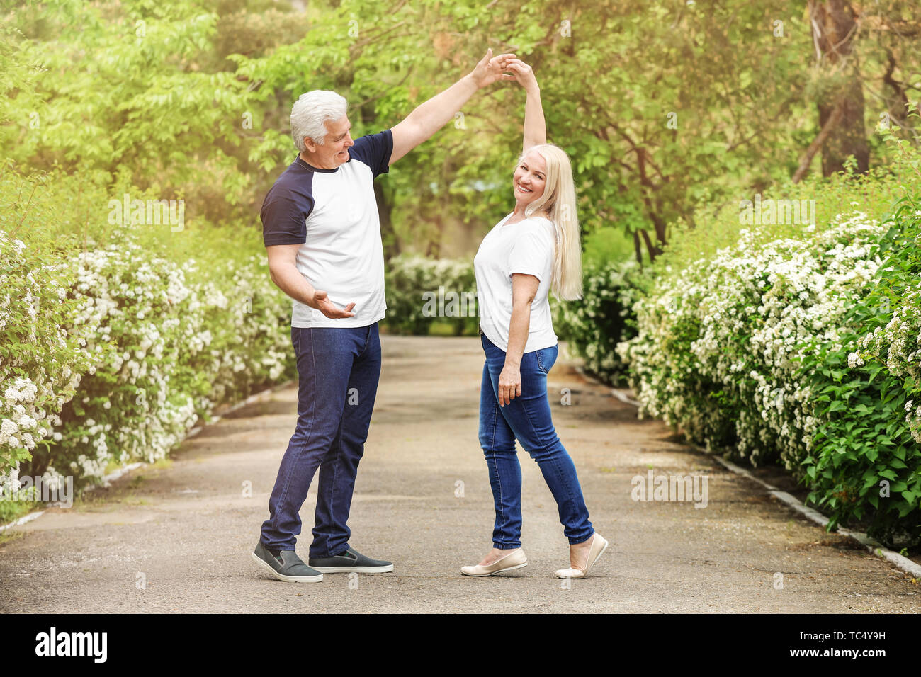 Portrait of happy mature couple dancing in park Stock Photo - Alamy