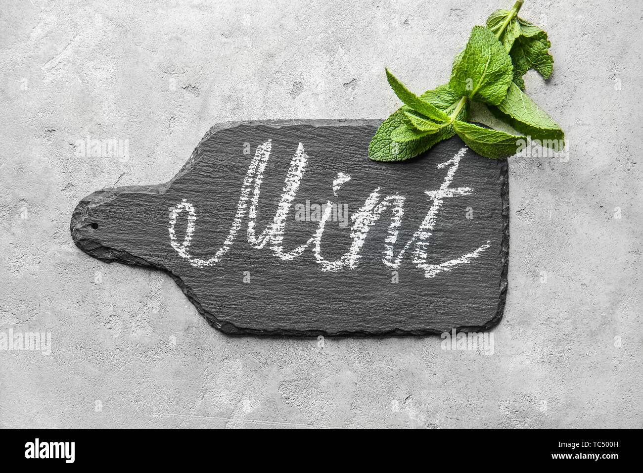 Slate board with written word MINT on light background Stock Photo - Alamy