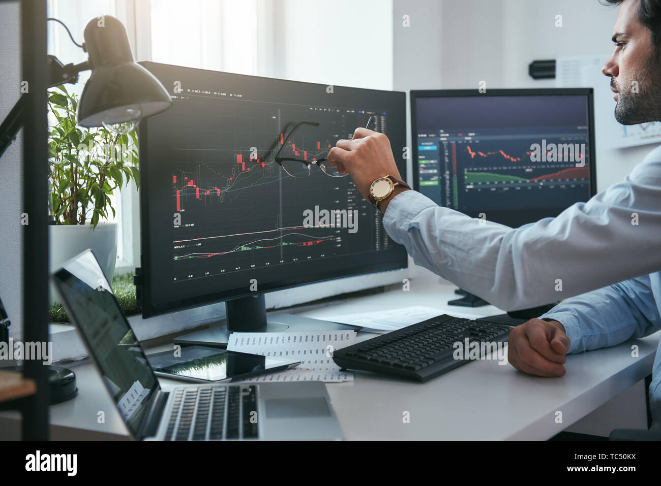 Forex Market Young Trader Is Pointing At Graphs On Computer - 