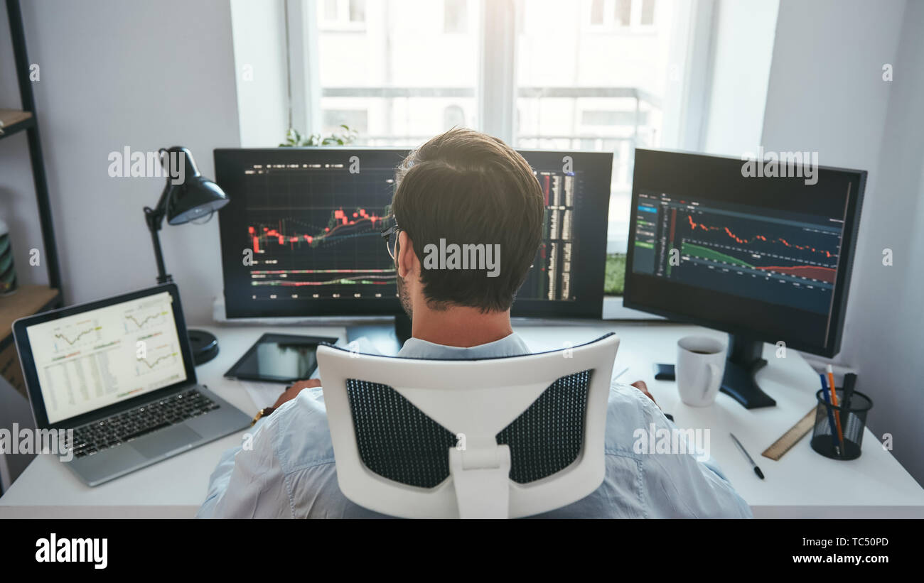 Trading Stocks Online Back View Of Young Businessman Or Trader - 