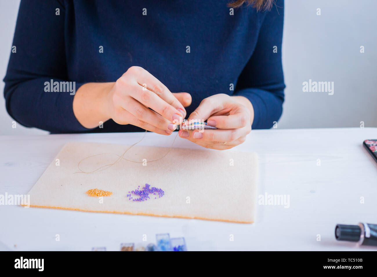 Designer making handmade brooch Stock Photo