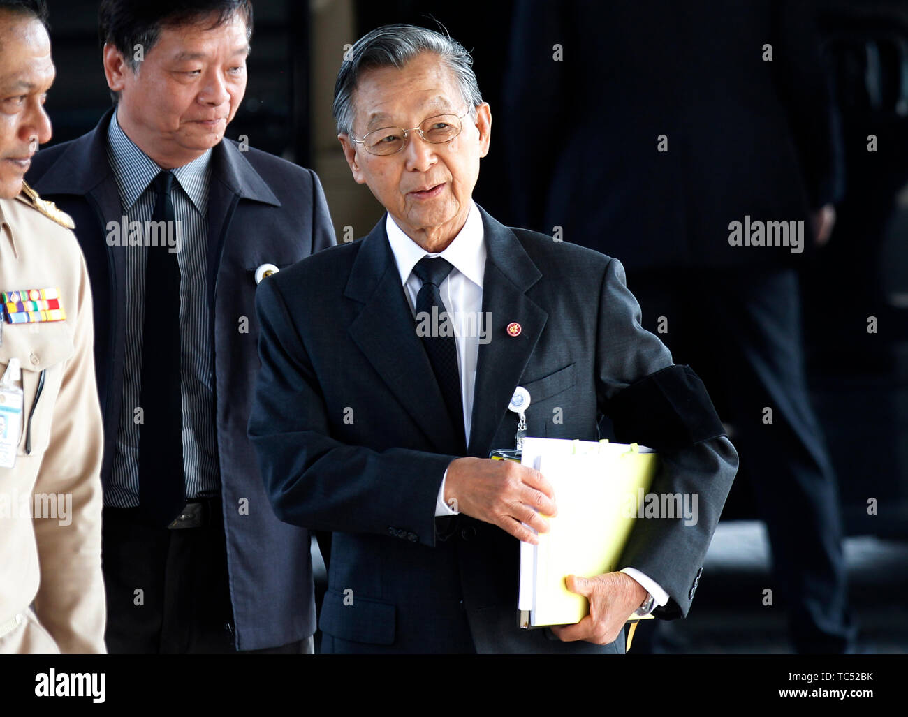 Parliament speaker, Chuan Leekpai (R) arrives to the parliament to vote for Thailand's new prime minister, at TOT Plc' auditorium in Bangkok. Stock Photo