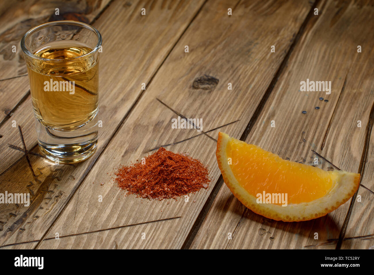 Mezcal Mexican drink with orange slices and worm salt on a vintage