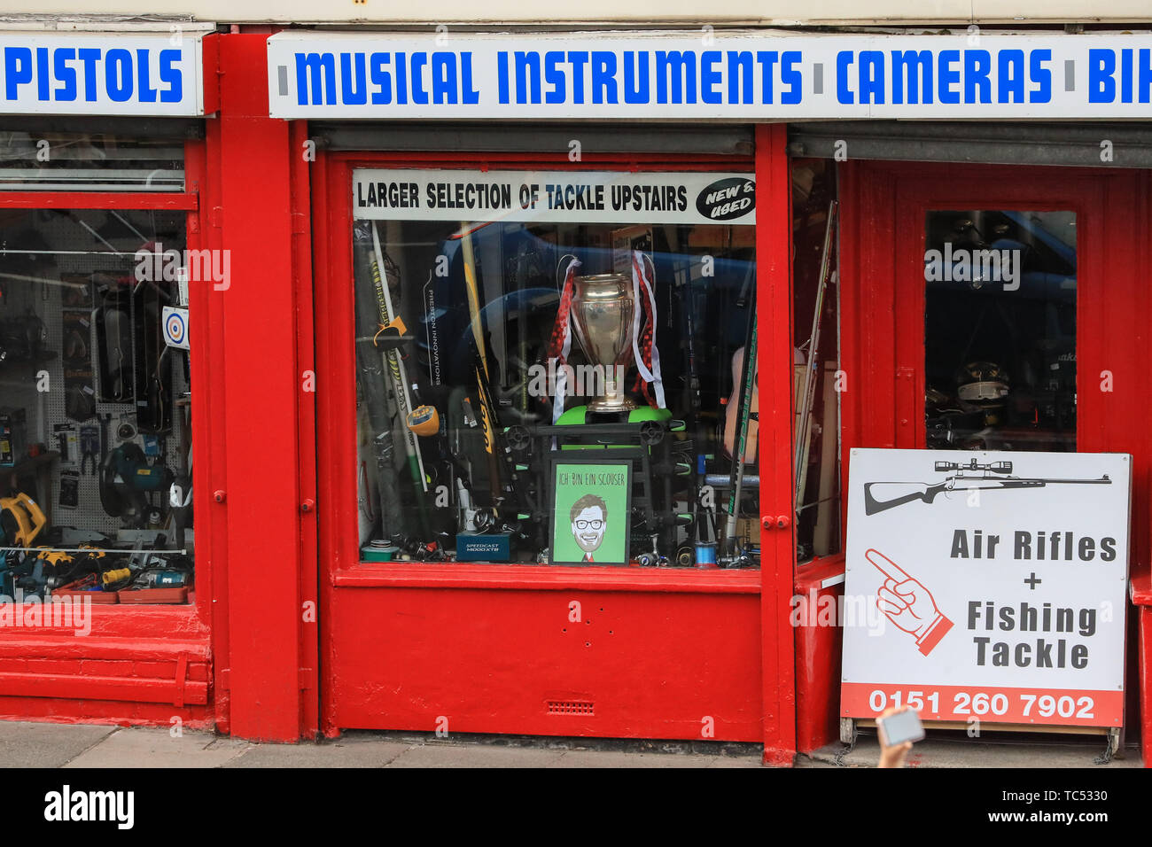 2nd June 2019 , Liverpool, England; UEFA Champions League, Liverpool FC Champions League winners celebrations and open top bus parade ; A shop displays a replica European cup with Liverpools ribbons on    Credit: Mark Cosgrove/News Images Stock Photo