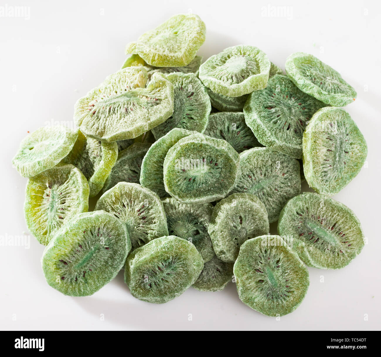 Pile of natural freezedried kiwifruit slices on white background