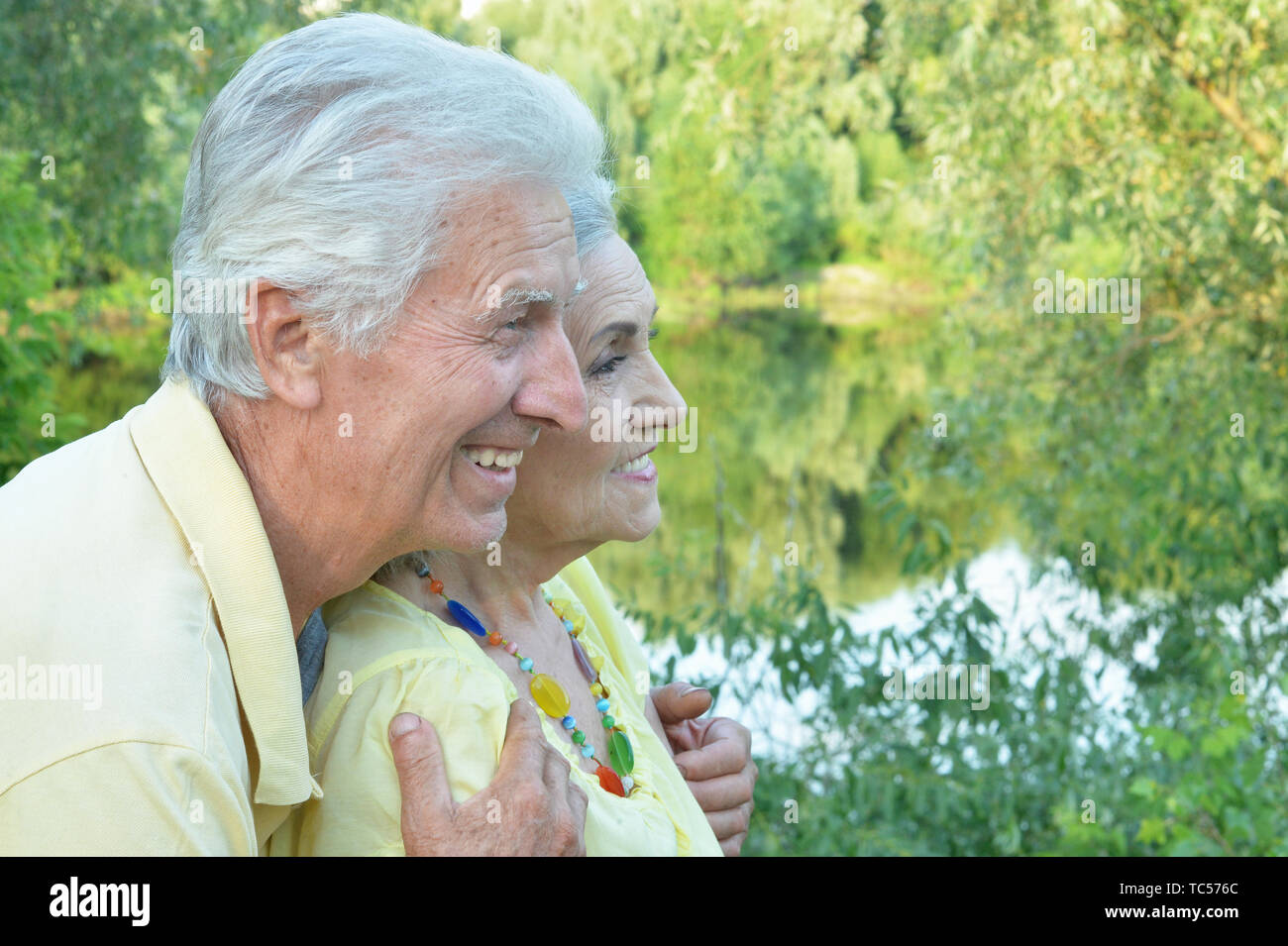 Beautiful senior couple posing and hugging in the park Stock Photo - Alamy