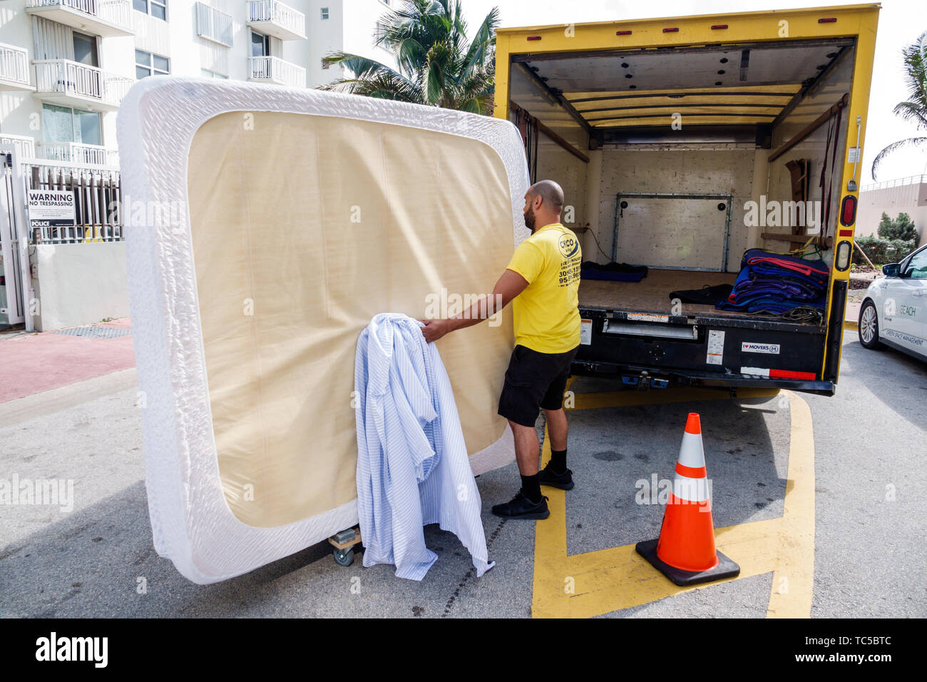 Miami Beach Florida,moving van company,movers,king size mattress,Hispanic man men male,employee working job,FL190228077 Stock Photo