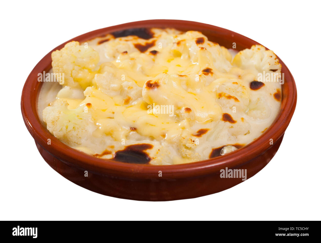 Dish of tasty baked with bechamel sauce cauliflower at clay pot. Isolated over white background Stock Photo