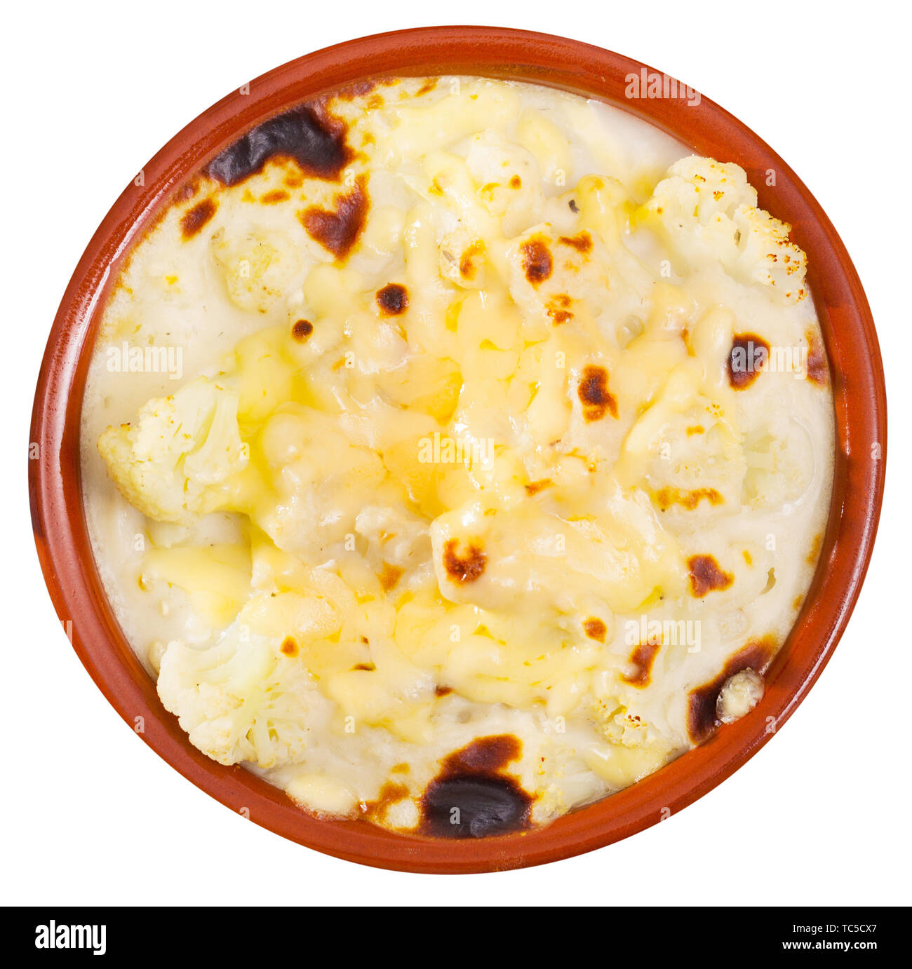 Image of tasty  baked cauliflower with bechamel sauce in clay pot. Isolated over white background Stock Photo