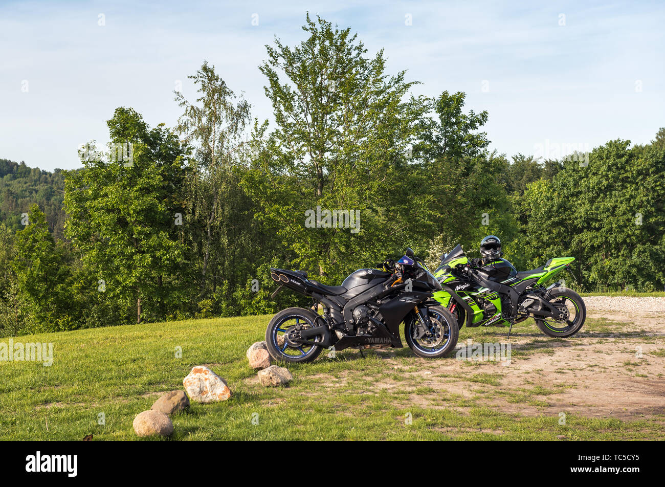 REBOSZEWO, POLAND - June 2, 2019: Sport motorcycles, Yamaha YZF-R1 and Kawasaki Ninja parked at the outdoor countryside Stock Photo