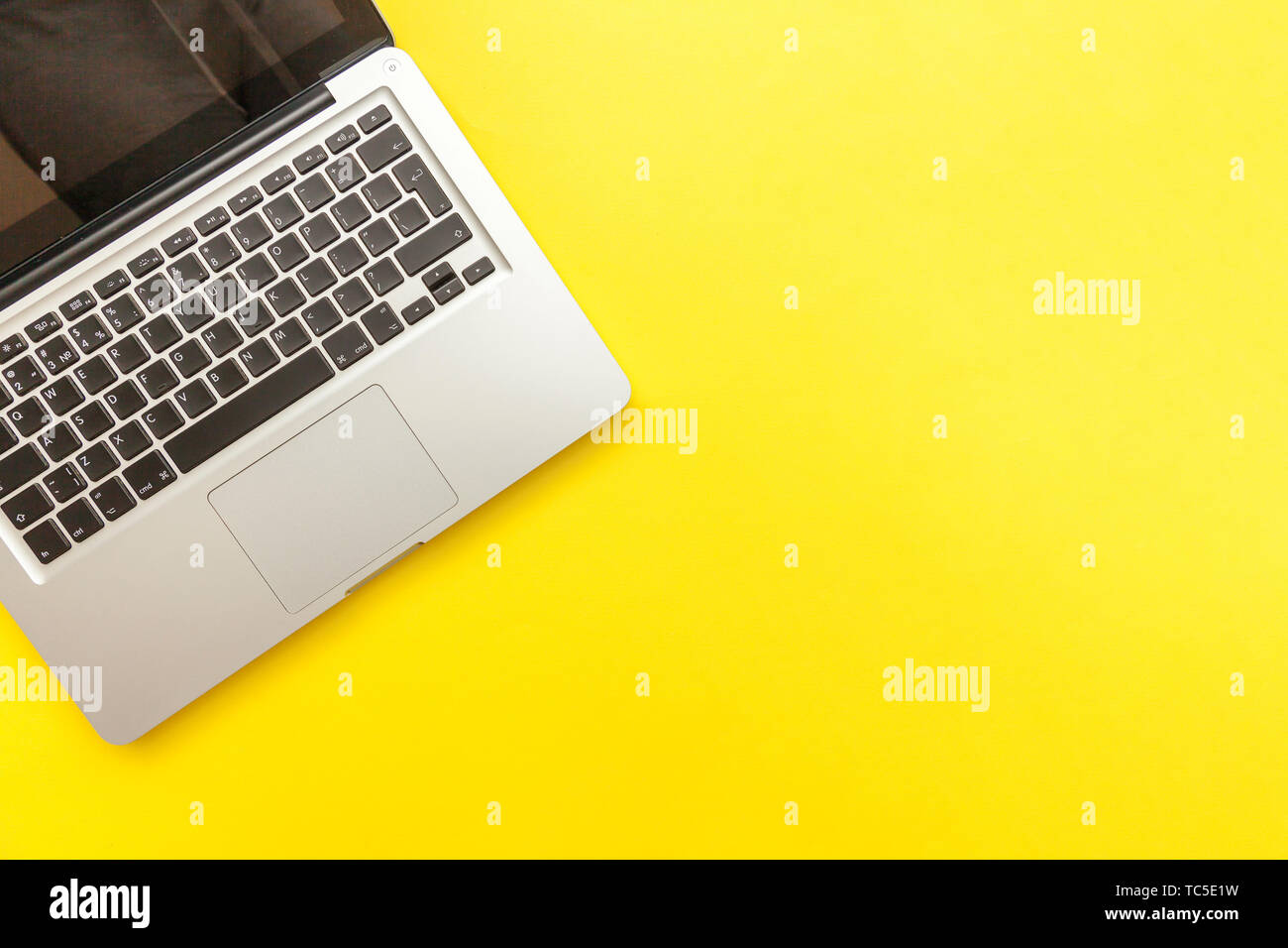 Keyboard laptop computer isolated on yellow desk background. Modern ...