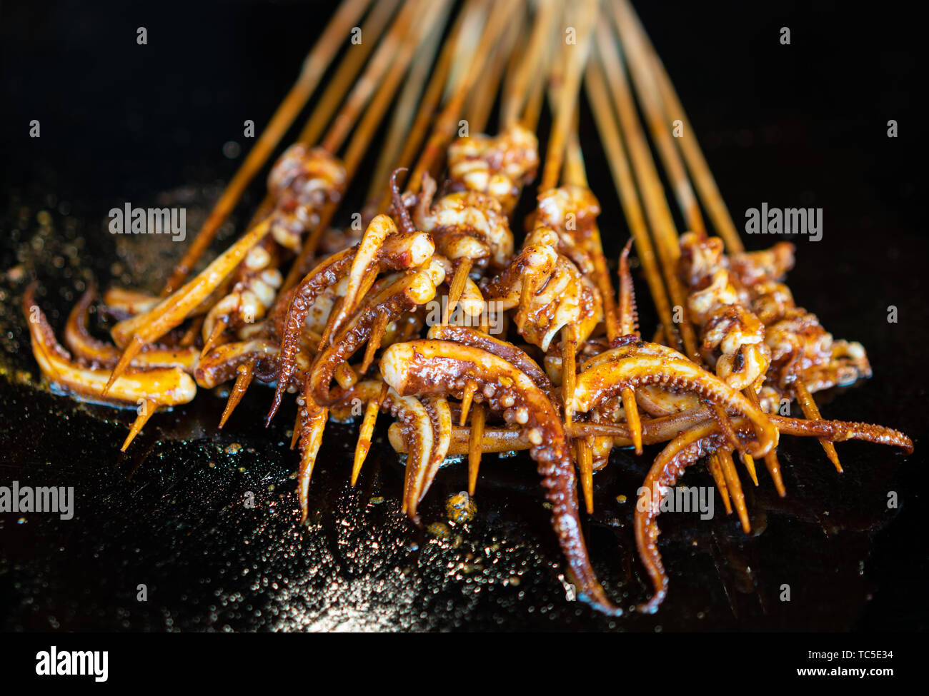 Grilled squid in the making Stock Photo