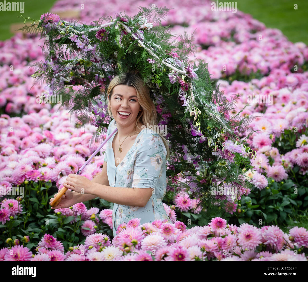 Ellie Mainwaring with a floral parasol made by celebrity florist Jonathan Moseley, during the