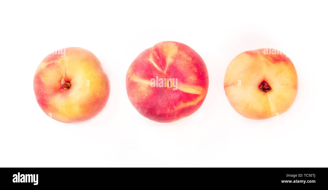 Vibrant organic flat saturn peaches, shot from the top on a white background Stock Photo