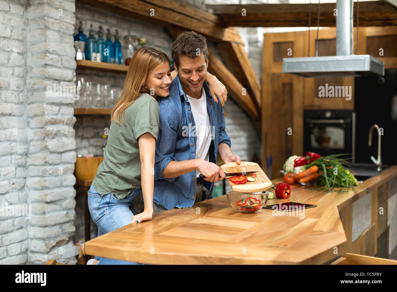 Lovely couple preparing food  in the kitchen Stock Photo