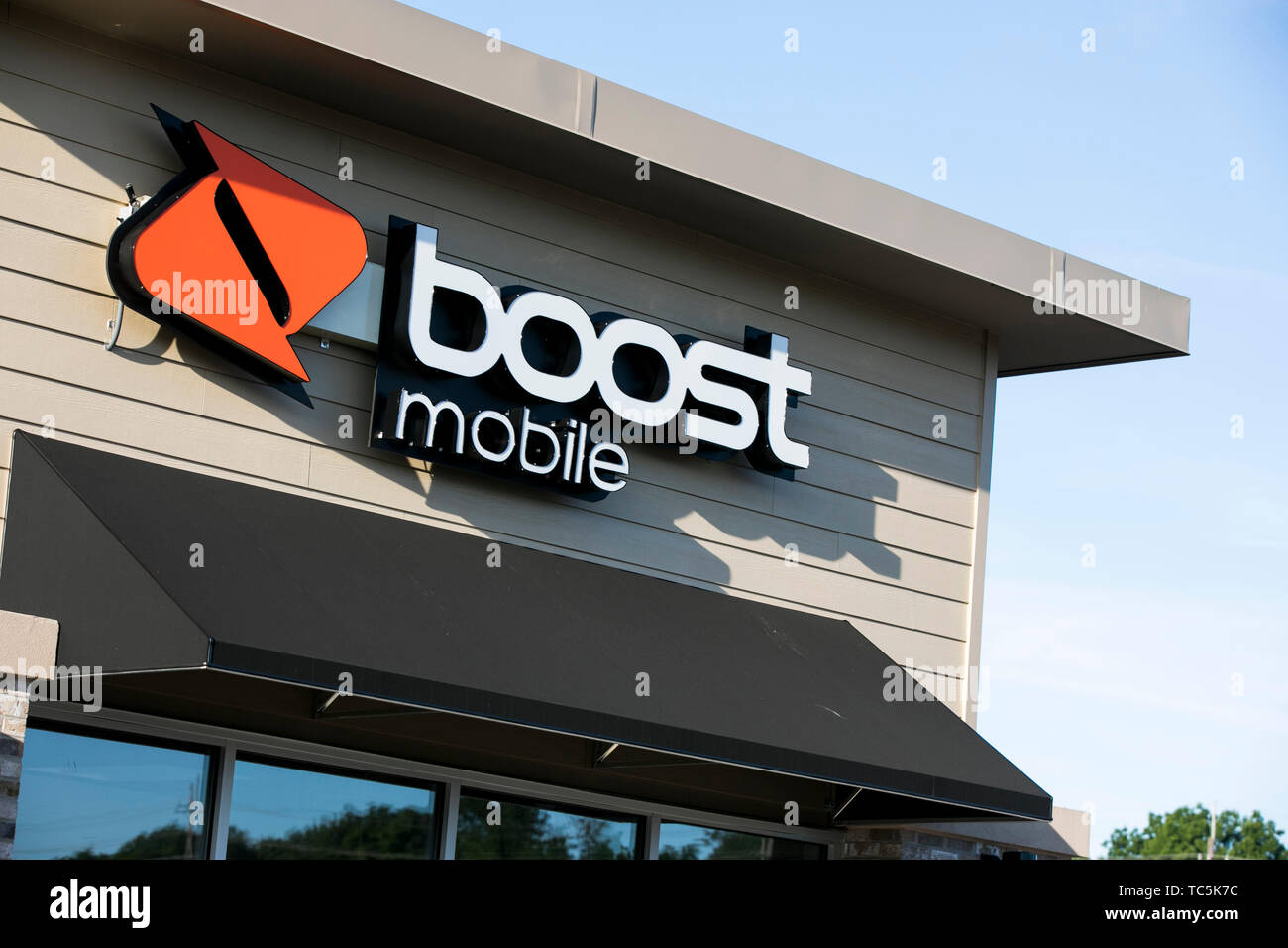 A logo sign outside of a Boost Mobile retail store location in Martinsburg, West Virginia on June 4, 2019. Stock Photo