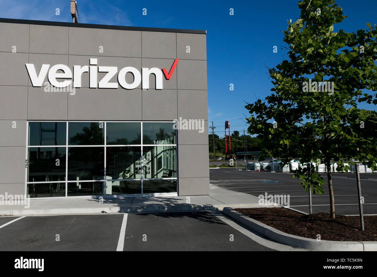 A logo sign outside of a Verizon Wireless retail store location in
