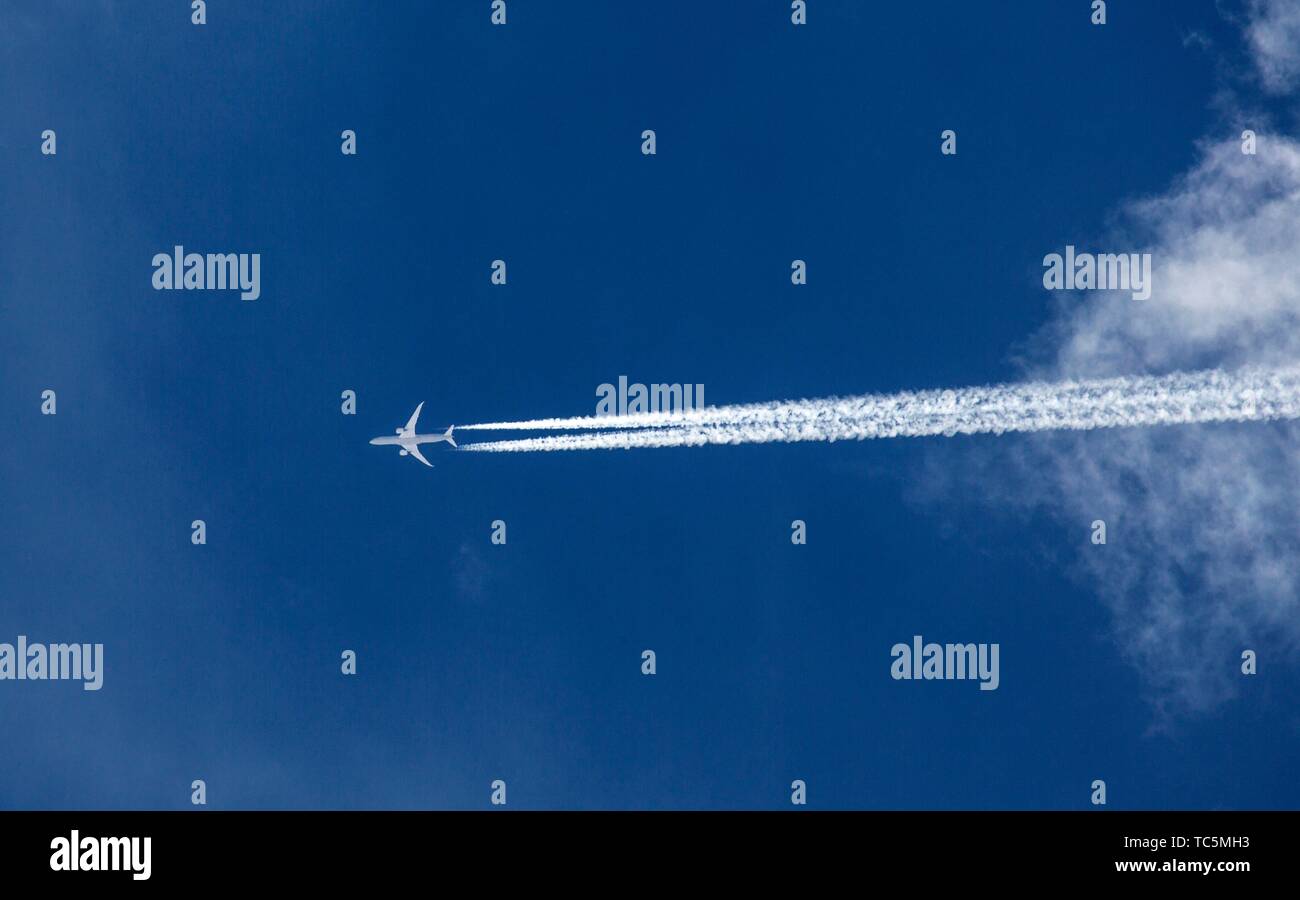 A jet travels through the blue skies of Southern Utah. Stock Photo