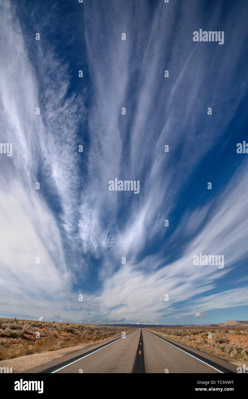 Dramatic and streaky clouds appear over the Souhern Utah landscape near Big Water. Stock Photo