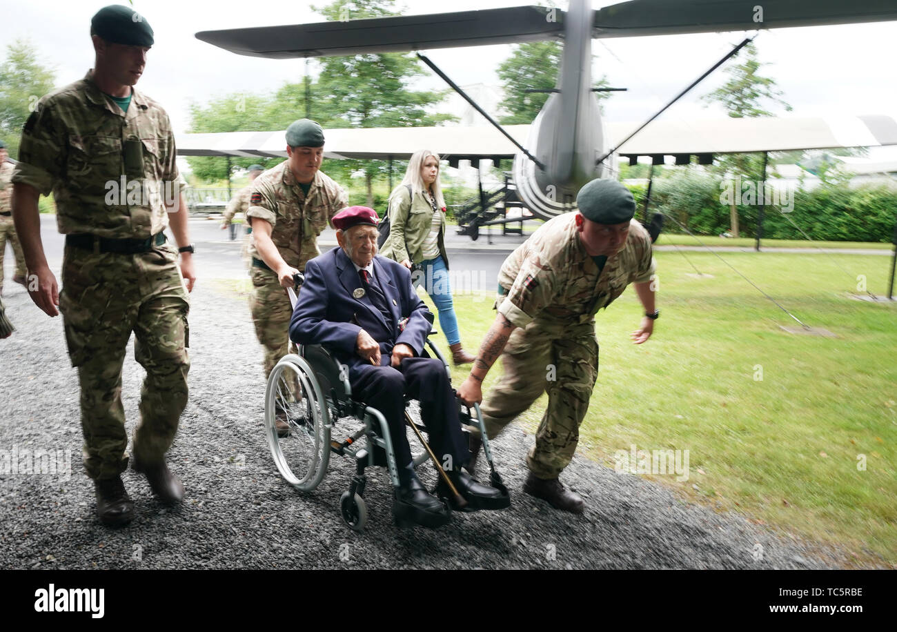 British army soldiers help Parachute Regiment (3 Para) veteran John Sleep, 98, from Windsor, who landed on Sword beach, during commemorations for the 75th anniversary of the D-Day landings. Stock Photo