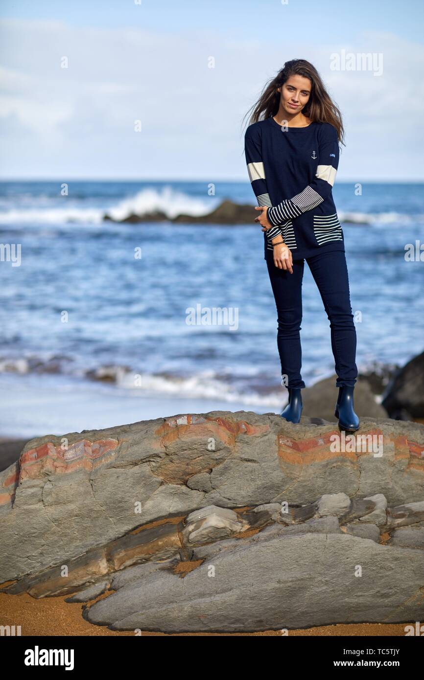 Young woman, Beach, Mutriku, Gipuzkoa, Basque Country, Spain Stock Photo