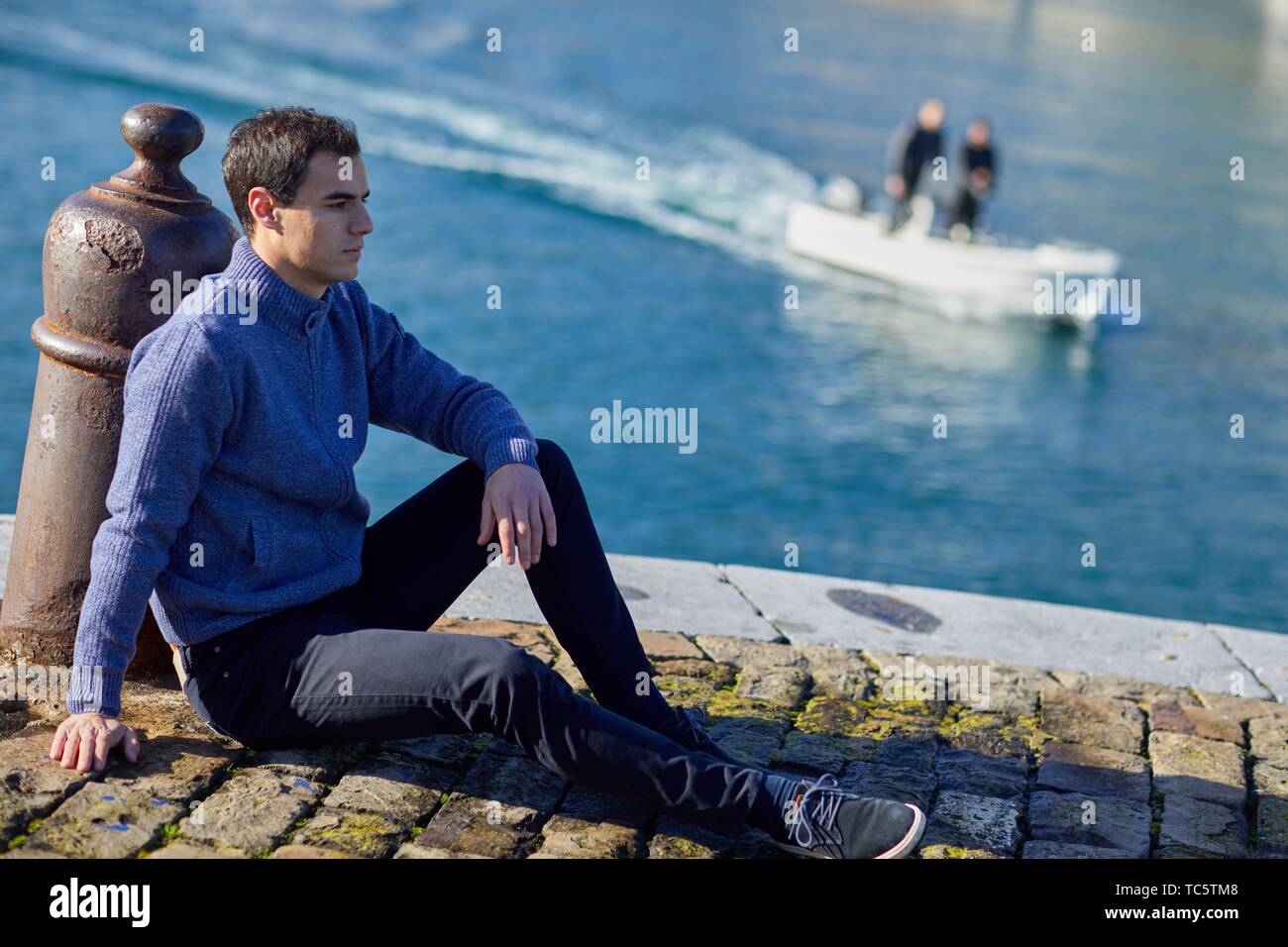 Young man, Port, Mutriku, Gipuzkoa, Basque Country, Spain Stock Photo