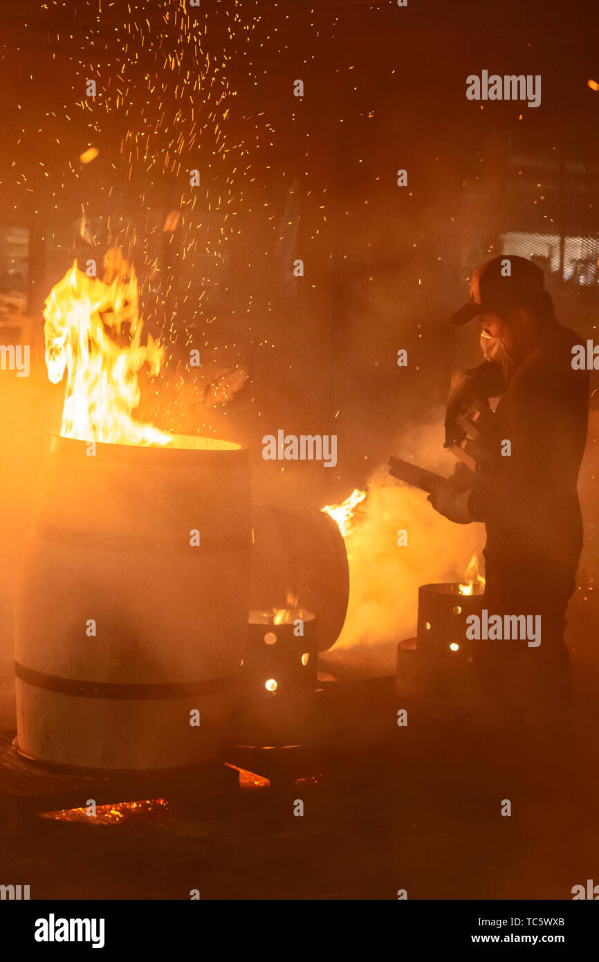 Louisville, Kentucky - Workers at Kelvin Cooperage make oak barrels for aging bourbon and wine. Barrels are charred to add flavor during the aging pro Stock Photo