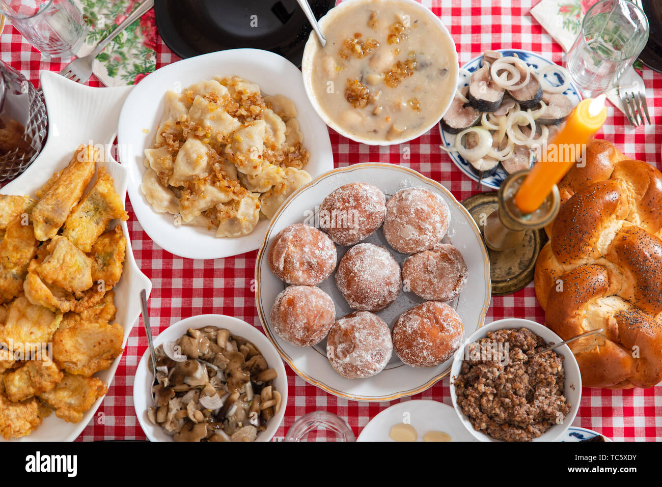 Traditional Christmas table in Ukraine. Twelve dishes: kutya, stewed fruit, dumplings with potatoes and cabbage, pickled mushrooms, donuts, garlic. Stock Photo