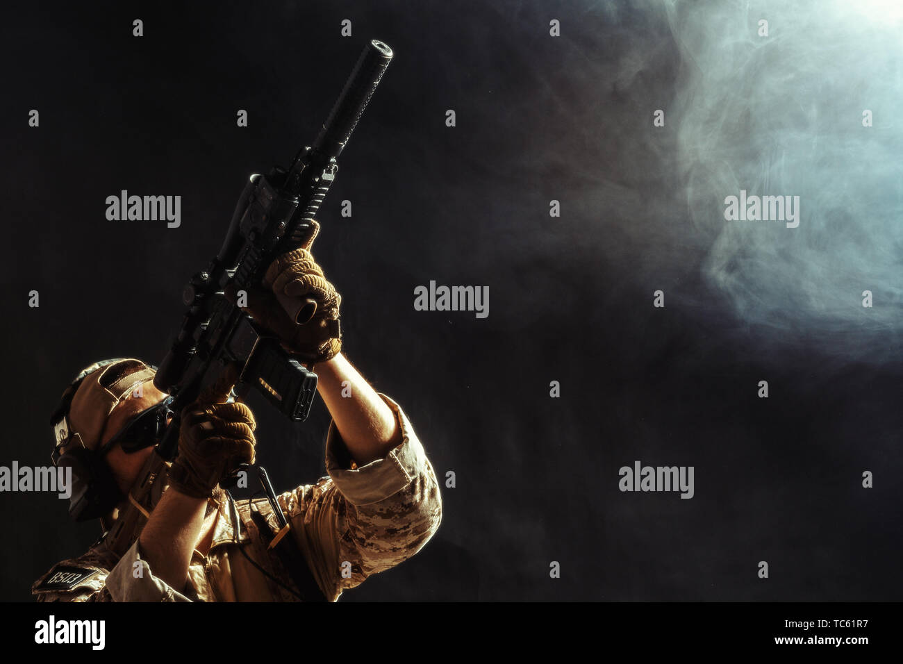 Special forces soldier with rifle on dark background Stock Photo - Alamy