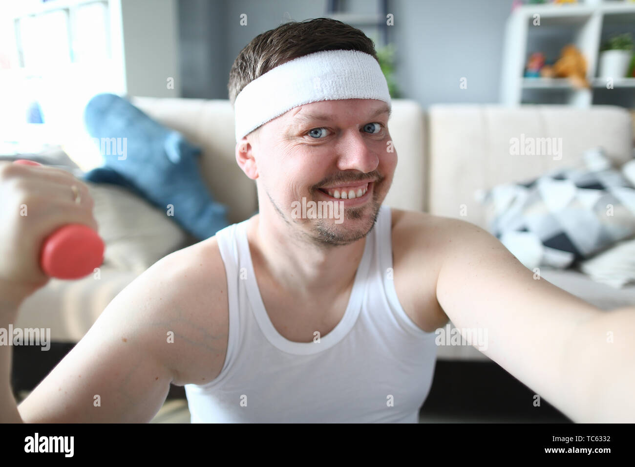 Smiling Sportsman with Dumbbell in Hand Portrait Stock Photo