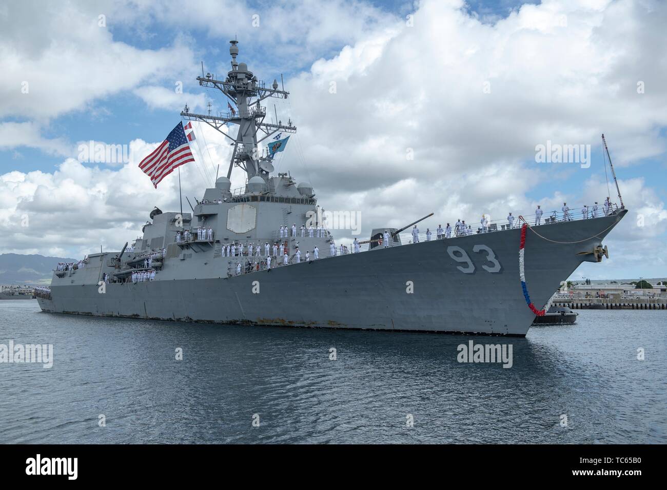 U.S. Navy sailors assigned to the Arleigh Burke-class guided-missile destroyer USS Chung Hoon man the rails as the ship pulls into homeport Joint Base Pearl Harbor-Hickam May 31, 2019 in Honolulu, Hawaii. Stock Photo
