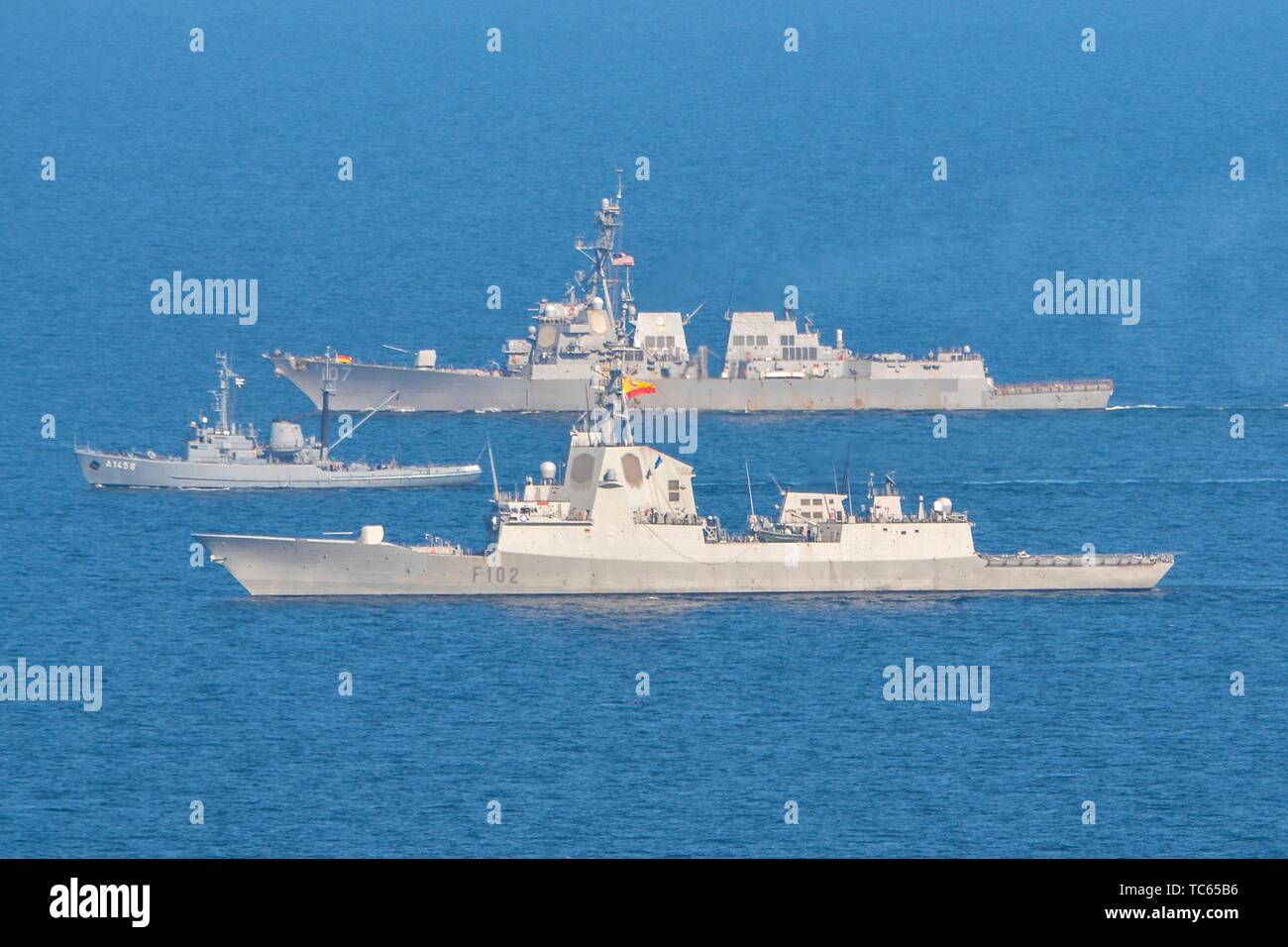 U.S. Navy sailors assigned to the Arleigh Burke-class guided-missile destroyer USS Gravely, back, sails in formation alongside the Spanish Naval ship frigate Almirante Juan de Borbon, front, and the German Navy tug DRL Fehmarn during a NATO exercise May 30, 2019 in the  Baltic Sea. Stock Photo