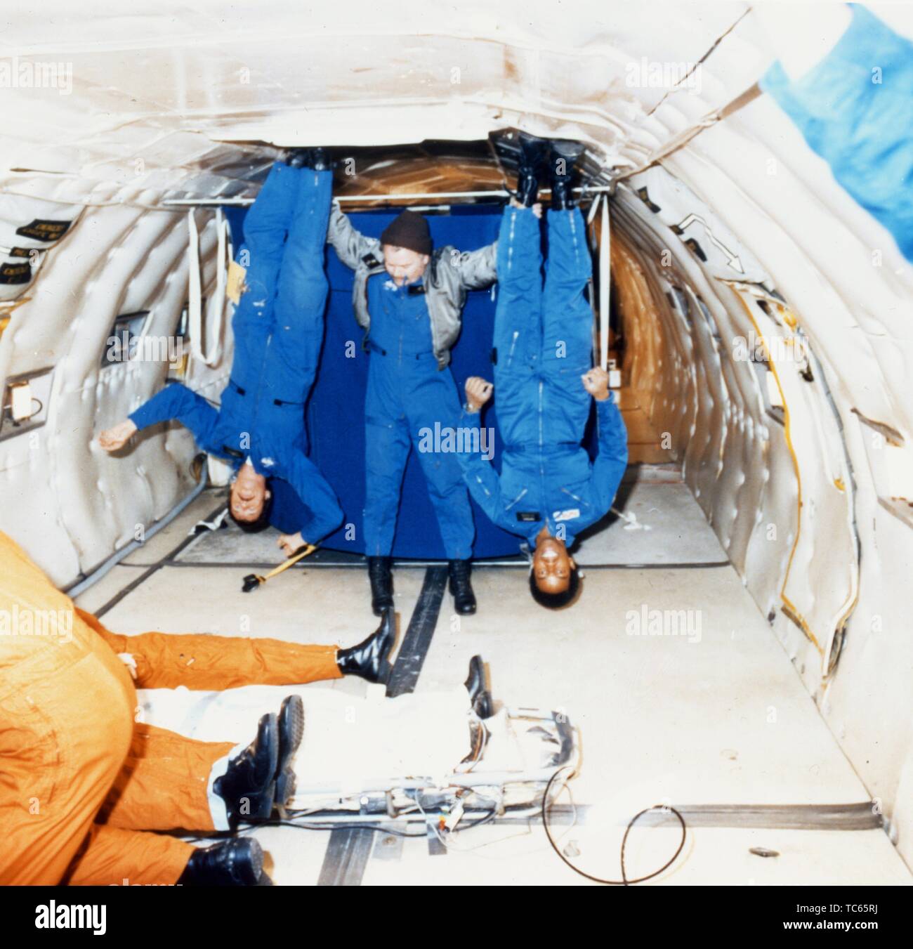 Astronaut Guion S Bluford and Aviation Safety Officer Charles F Hayes assisted by CP Stanley aboard a KC-135 aircraft during a zero-gravity flight, March 2, 1979. Image courtesy National Aeronautics and Space Administration (NASA). () Stock Photo