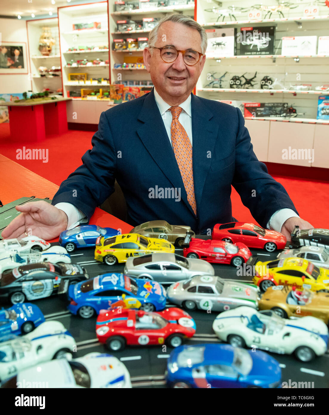 Nuremberg, Germany. 28th May, 2019. Kurt Hesse, CEO of Autec AG, sits in his company's showroom in front of remote-controlled vehicles. A dispute over the design of the Porsche 911 and the VW Caddy and T5 models is occupying the EU judges in Luxembourg. The case is attributable to the two model car manufacturers Autec and Rietze. At the EU Intellectual Property Office in Alicante, they had the so-called design patents, which protect the appearance of the vehicles throughout Europe, cancelled. Credit: Daniel Karmann/dpa/Alamy Live News Stock Photo